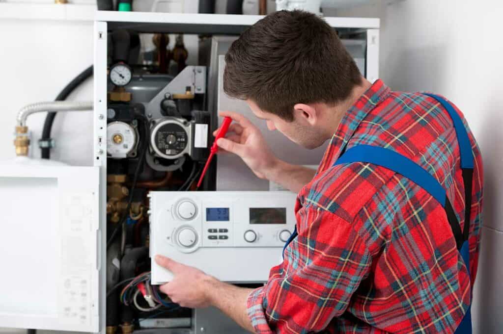 Technician performing maintenance on an HVAC system