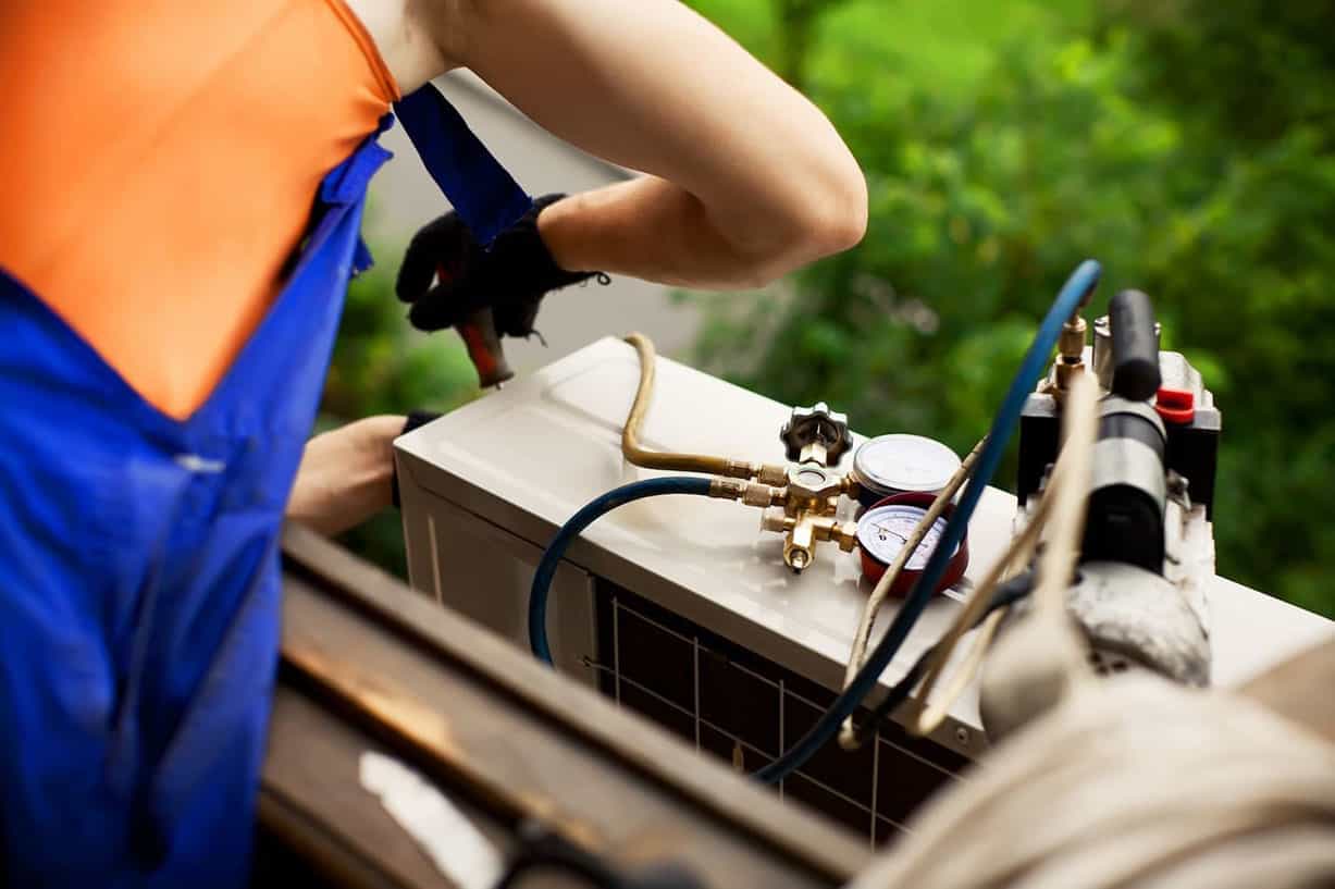 Technician repairing a ventilation unit