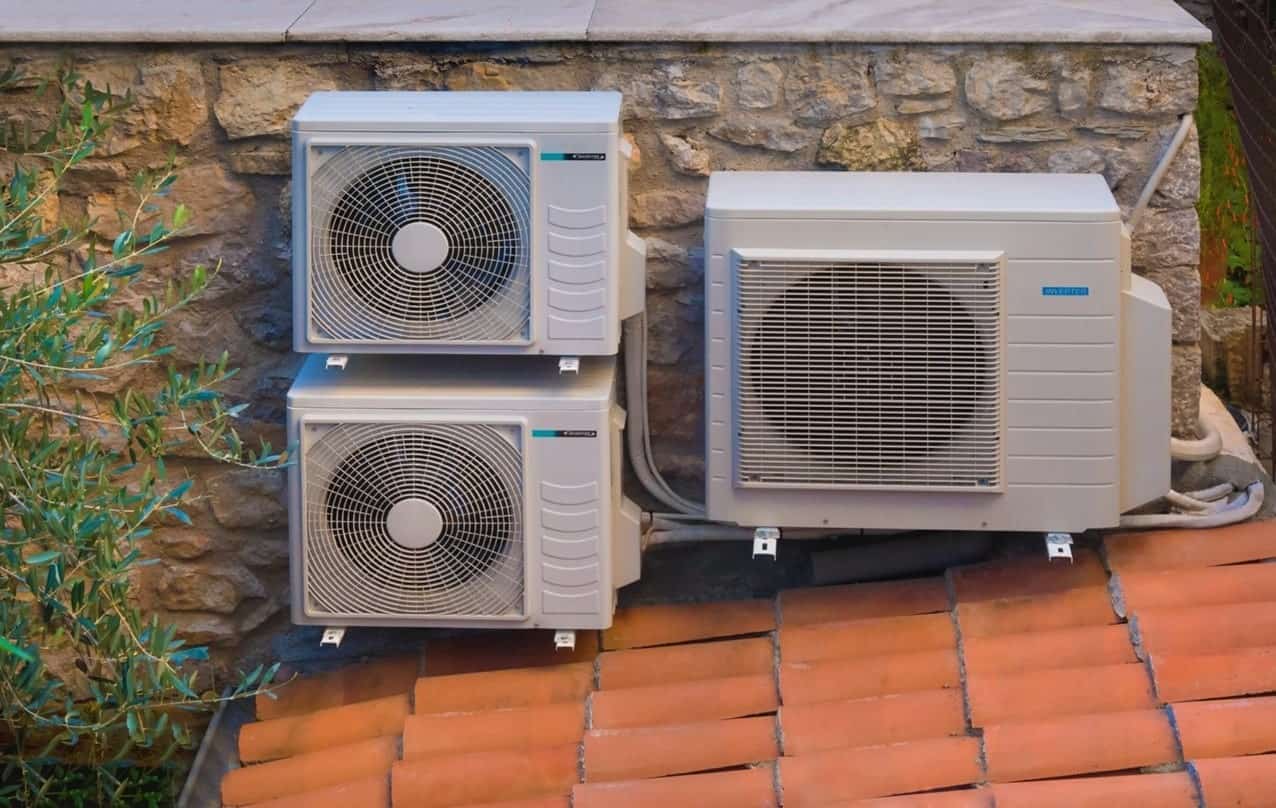 A heat pump and air conditioner on a roof