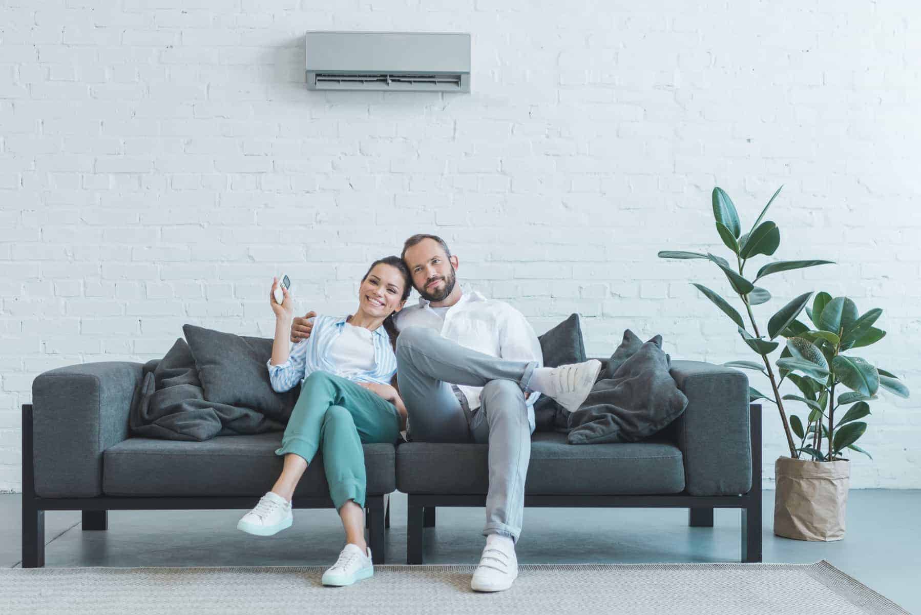 Picture of a couple under their air conditioner