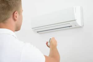 Photo of a person adjusting their air conditioner